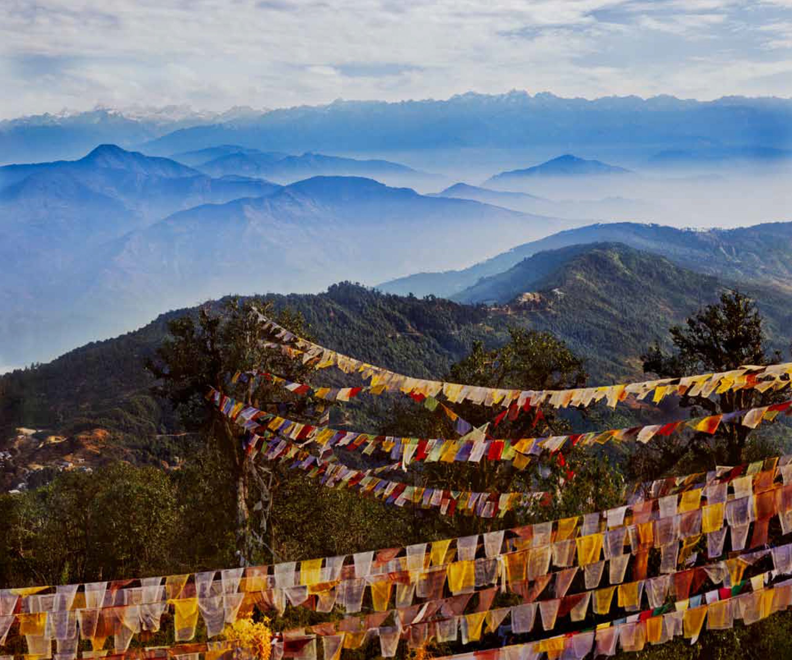 Photo of prayer flags on a mountain top